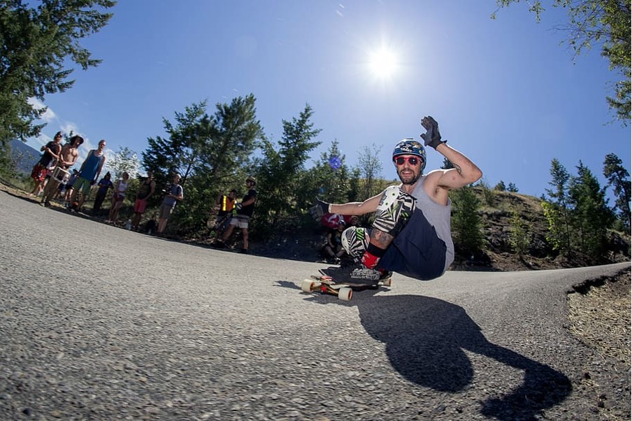 A thirty-year-old man is riding his longboard (source)