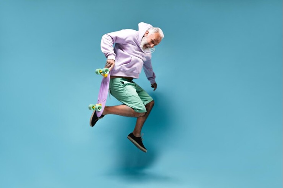 A 50-year-old man is jumping with his skateboard